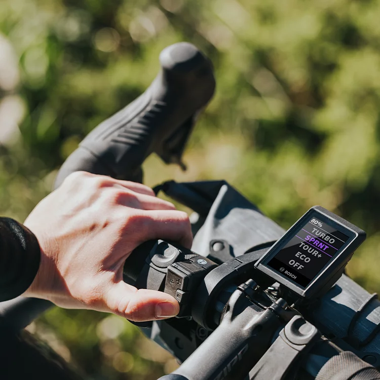 Close-up of a bicycle handlebar with Kiox display set in Sprint mode.
