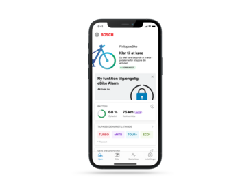Skærmbillede af hjemfanen i eBike Flow-appen, der viser den nye eBike Alarm Service, som tilbyder en ekstra sikkerhedsfunktion til eBike-brugere.